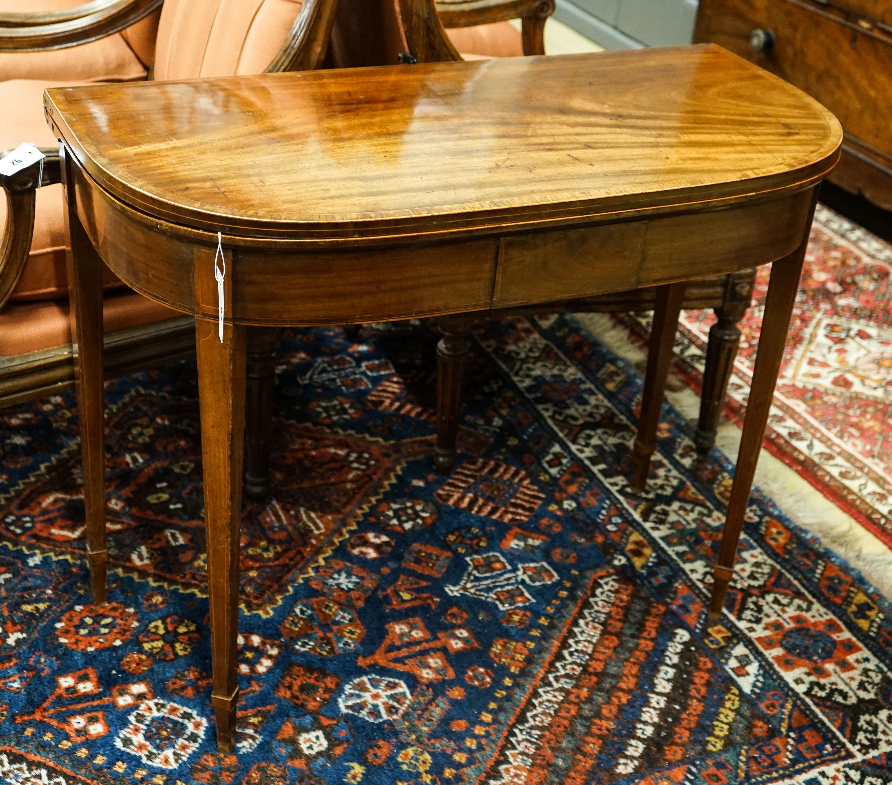 A George III banded mahogany D shaped folding card table, width 91cm, depth 45cm, height 72cm